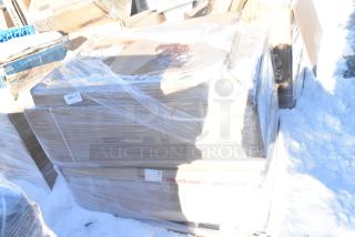 Stack of wrapped boxes containing brand new scratch and dent items, including dirty dish tables and cake pans, labeled "Clean Dish Table 600 CDT 48L."