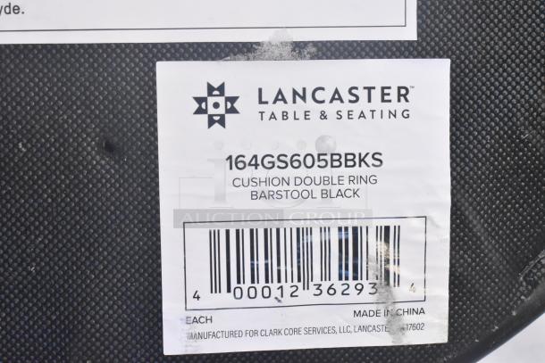 Alt text: Lancaster Table & Seating label on black barstool base, model 164GS605BBKS, indicating "Cushion Double Ring, Barstool Black."