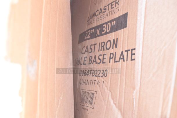 Cardboard box labeled "Lancaster Table & Seating," containing a 22" x 30" cast iron table base plate, model #164TB2230.
