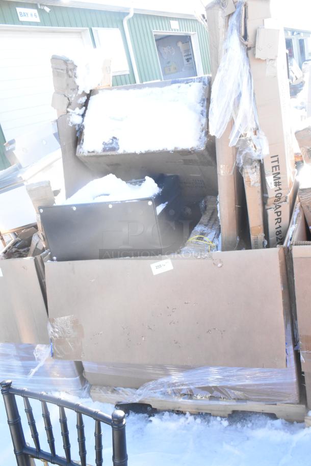 Auction lot of 7 new scratch and dent items including Bakers Lane Ingredient Bin and Regency Table. Packaging visible. Snow present.