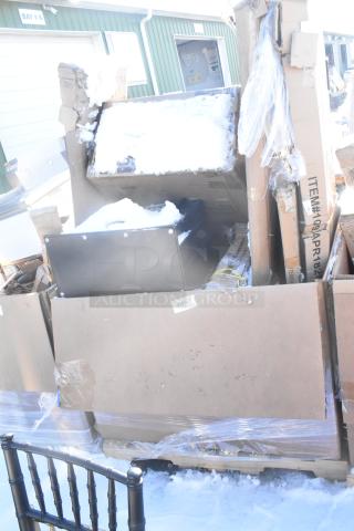 Auction lot of 7 new scratch and dent items including Bakers Lane Ingredient Bin and Regency Table. Packaging visible. Snow present.