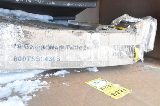 Damaged packaging for 18-gauge work table model 600TSS24306, showing visible wear and shipping labels B223.