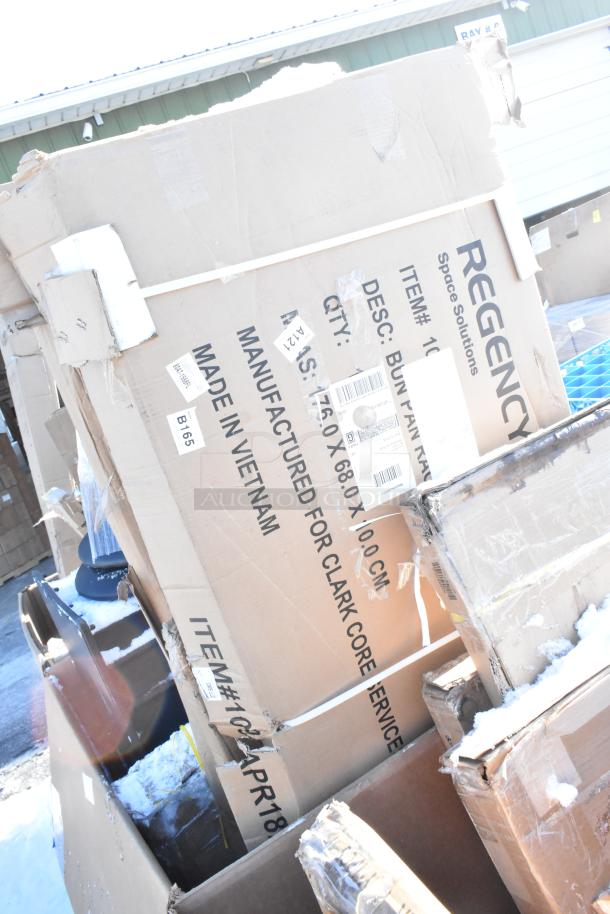 Cardboard boxes with Regency branding, containing new scratch and dent items. Labels specify made in Vietnam, item ID 10PR186.