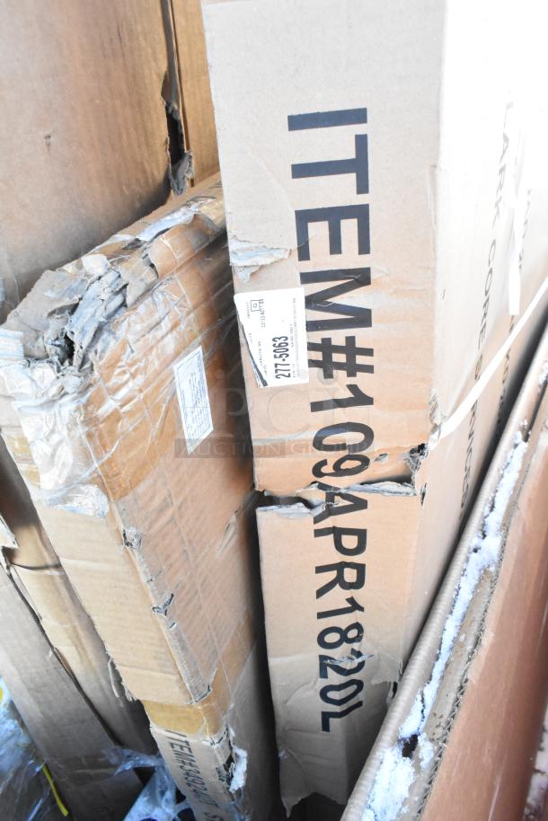 Damaged cardboard boxes containing seven new scratch and dent items, including Bakers Lane ingredient bin and Regency equipment.