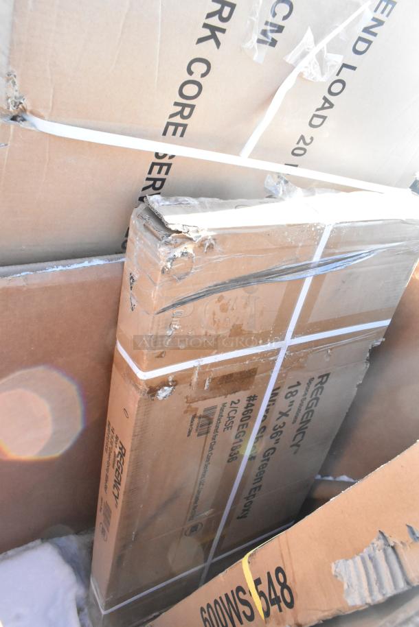 Boxes of new scratch and dent items, including Regency shelves. Some damage visible. Includes baby changing station.