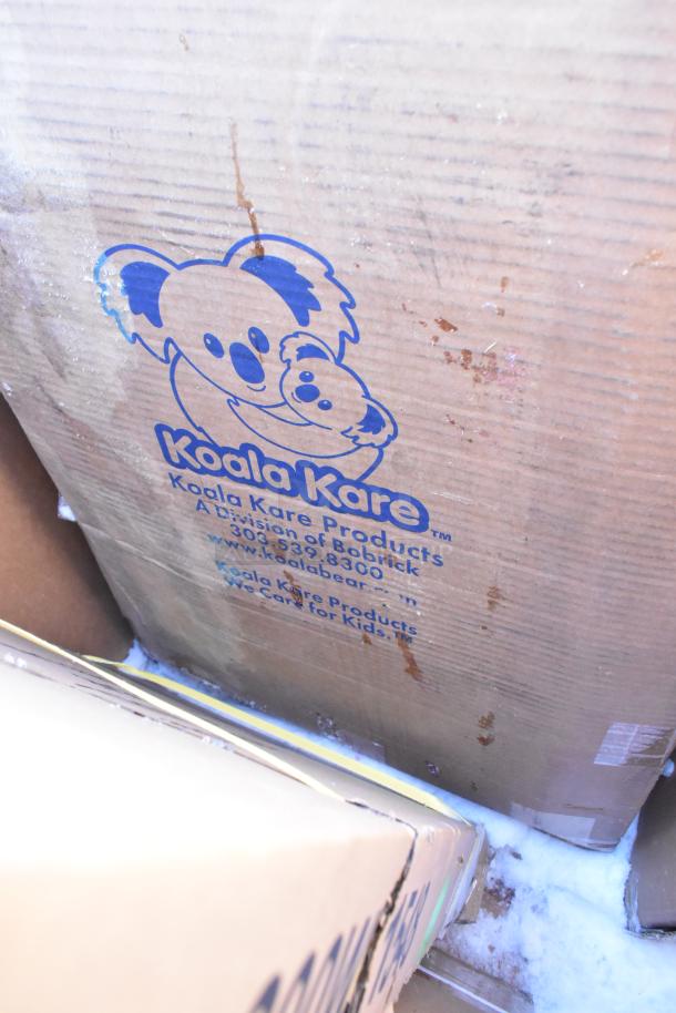 Box with Koala Kare Products logo, indicating baby changing station inside; scratch and dent condition.