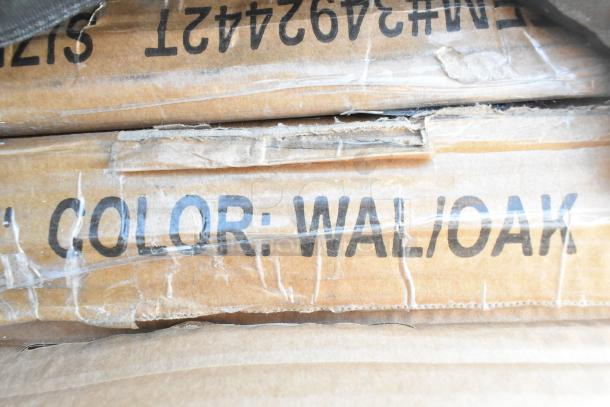 Boxed items labeled "Color: Walnut Oak," indicating color for auction lot of new scratch and dent shelves and baby changing station.