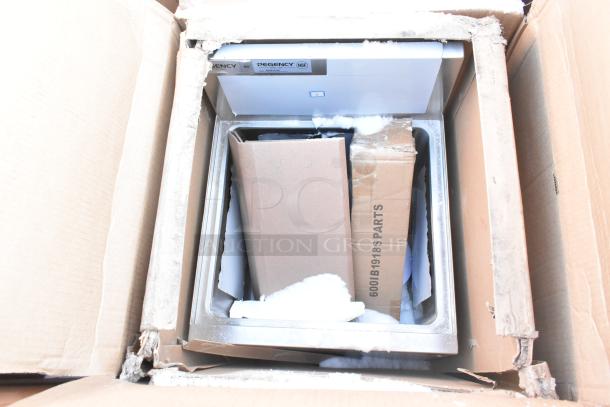 Box of new "scratch and dent" items including Regency shelves, baby changing station parts; visible packaging damage.