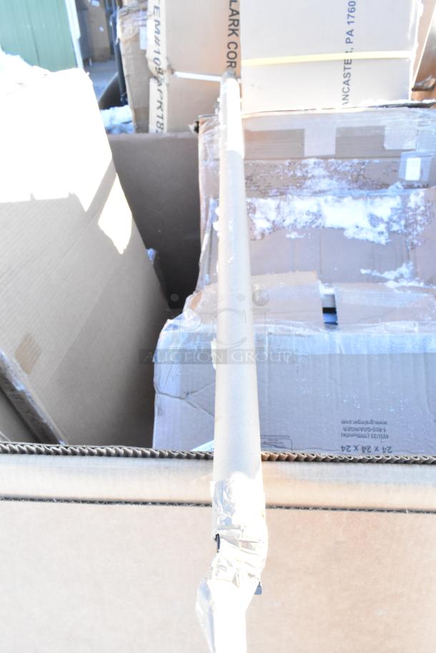 Cardboard boxes containing 10 new scratch and dent items, including shelves and a baby changing station, in a warehouse setting.