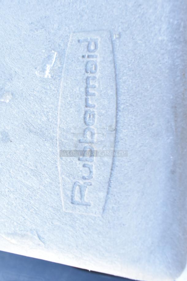 Rubbermaid poly trash can shell with swinging flap lid, displaying textured surface. Contains cup dispensers.