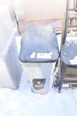 Black and gray Poly Trash Can with lid. Stickers on lid and front. Moderate wear and marks. Suitable for outdoor use.