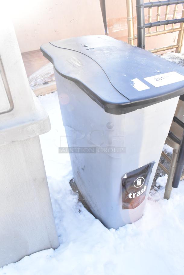 Poly Trash Can with black lid, visible "trash" label, in snowy outdoor setting. Appears in good condition.