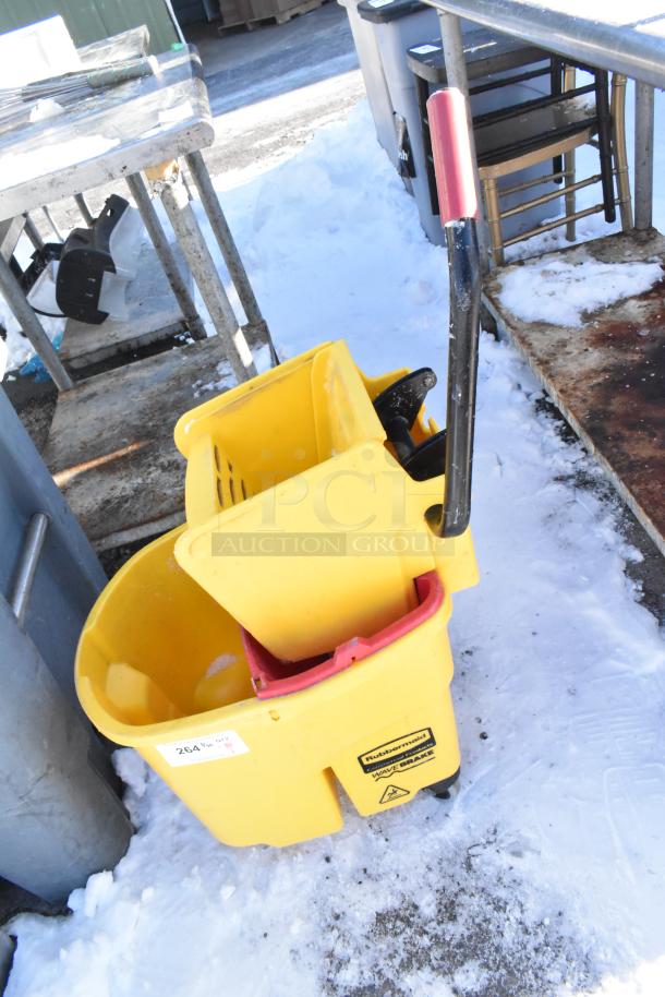 Rubbermaid yellow poly mop bucket with wringing attachment, commercial casters; slight wear, Rubbermaid WaveBrake label visible.