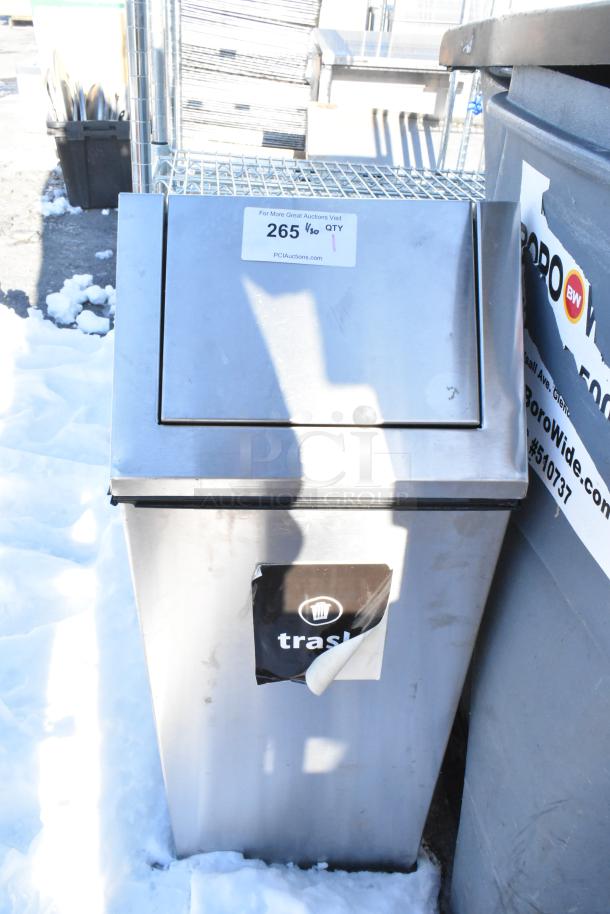 Metal trash can shell with front flap. Features a sticker marked "trash." Visible auction label reads "265" by PCI Auctions.