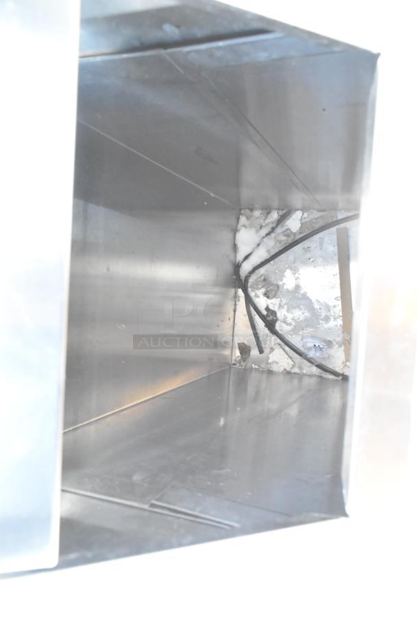 Metal trash can shell, stainless steel, interior view, slight abrasions, signs of use, suitable for commercial or industrial use.