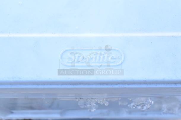 Sterilite branding on white plastic, part of a lot with 4 poly drawers, napkin dispenser, and whisks. Auction item.