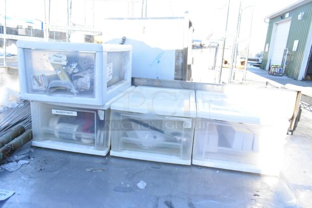 Four plastic poly drawers labeled "Fridge Lights" and "Blender Parts," a metal napkin dispenser, and two whisks.
