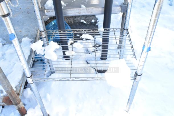 Chrome finish 2-tier wire shelving unit with snow-covered wire racks, features sturdy metal legs and a wooden top.