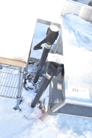 2 Winco CGS-38K stanchions with black posts and retractable belts, used condition, marked with auction tags "271" and "272".
