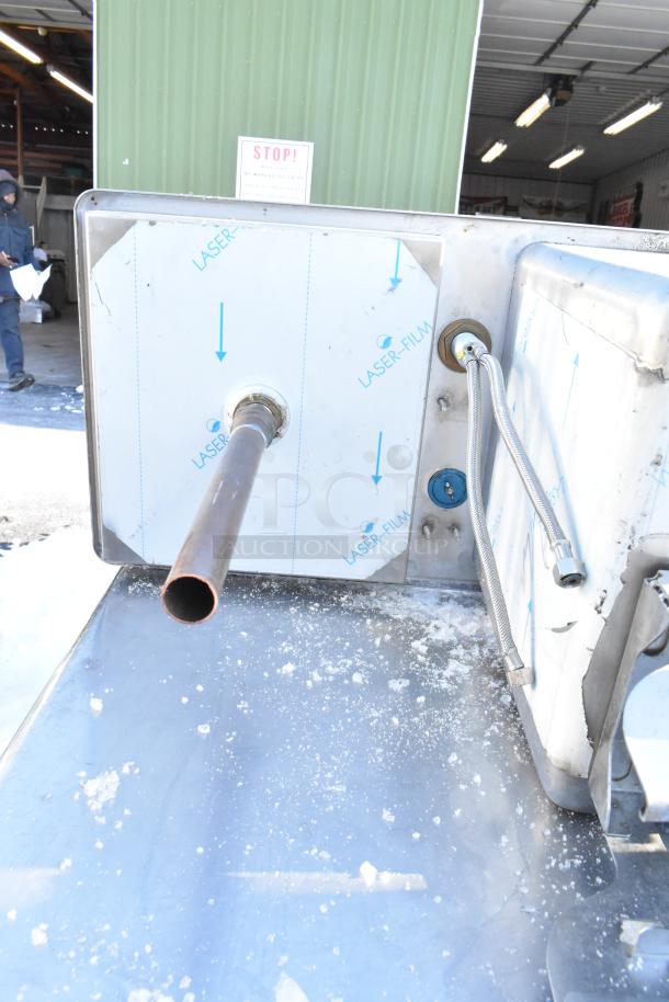 Stainless steel drop-in sink with faucet connections, shown from the side. New condition with protective film.