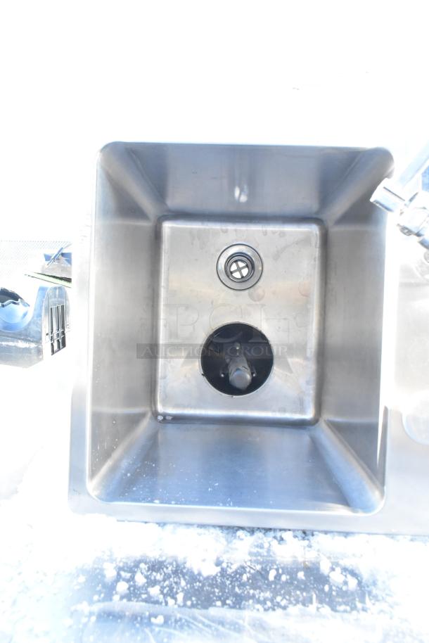 Stainless steel drop-in sink, square design, features drain opening. Appears in good condition; no visible labels or markings.