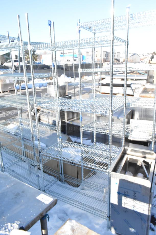 Chrome finish 4 tier wire shelving unit, outdoor setting, snow-covered ground, requires buyer dismantling.