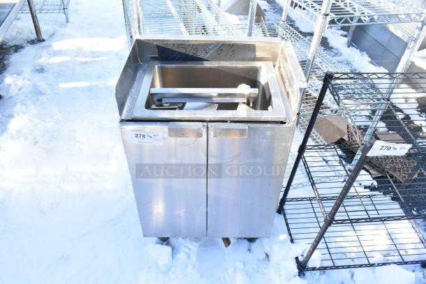 Stainless steel commercial basin with two doors, includes integrated sink, tag labeled "278", snowy outdoor setting.