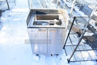 Stainless steel commercial basin with two doors, includes integrated sink, tag labeled "278", snowy outdoor setting.