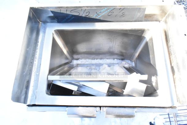 Stainless steel commercial basin with two doors, featuring durable construction and visible internal storage space.