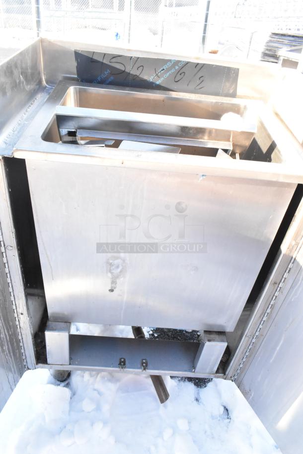 Stainless steel commercial basin with two doors. Features durable construction. Visible surface marks indicate prior use.