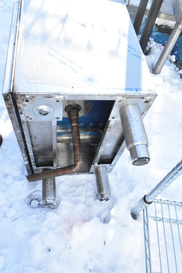 Stainless steel commercial basin with two doors, exposed piping. Used condition. Ideal for commercial kitchens.