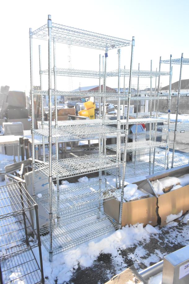 Chrome finish 6 tier wire shelving unit in outdoor setting. Buyers must dismantle. Consider freight charges.