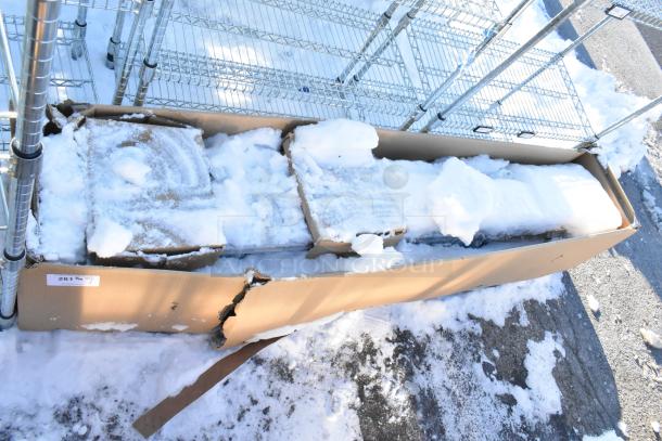 Cardboard box containing Hoshizaki HNC-210BA-L-SLH sushi display case with snow on top, partially visible. Box shows wear.