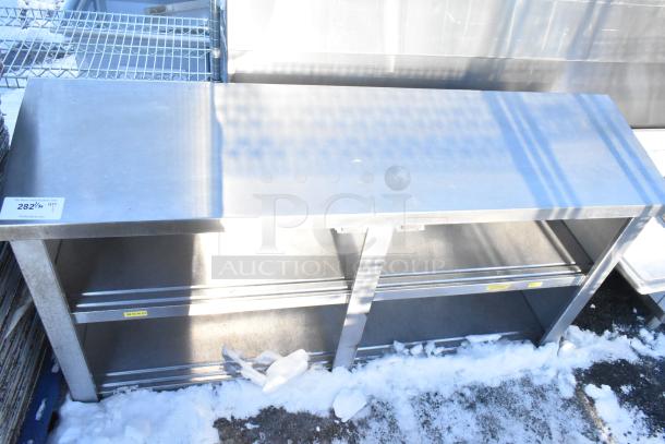Stainless steel counter with two under shelves, used condition. Auction tag reads "282" with details.