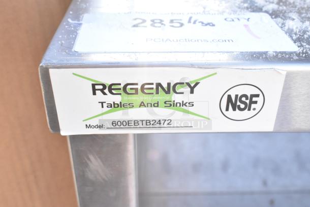 Regency 600EBTB2472 stainless steel table with adjustable midshelf and 6" backsplash, NSF certified label visible.