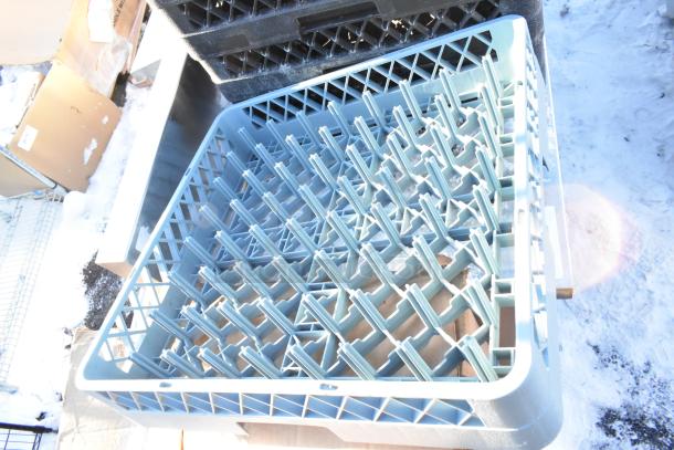 Lot of 14 poly dish caddies, stackable and durable, shown in snowy outdoor setting. Suitable for commercial use.