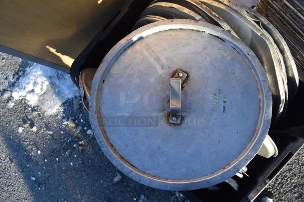 Metal stock pot lid with handle; marked "ROYAL RSPF-60L." Accompanied by baking pans and pot lids.