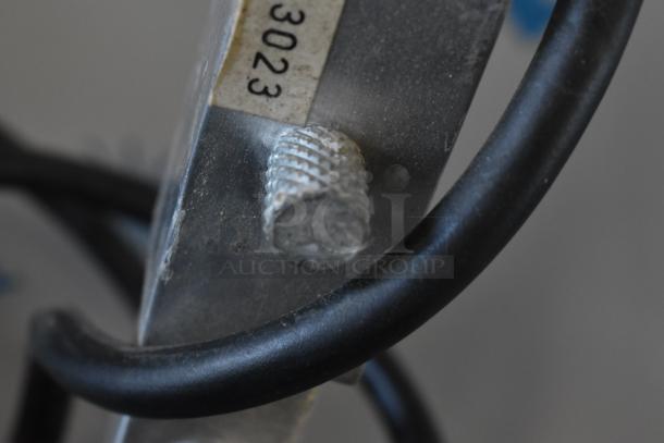 Close-up of Avantco W62 warming lamp component, featuring metal knob and black cable. Model label partially visible.