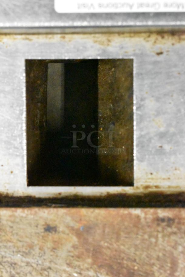 Alt text: American Range commercial countertop flat top griddle with thermostatic controls, showing surface wear.