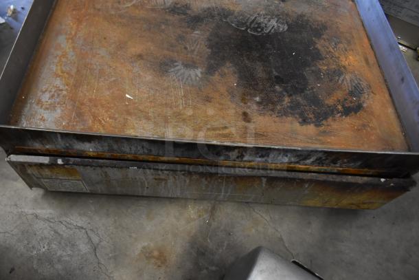 American Range Commercial Flat Top Griddle, worn surface, thermostatic controls, stainless steel, heavily used condition.