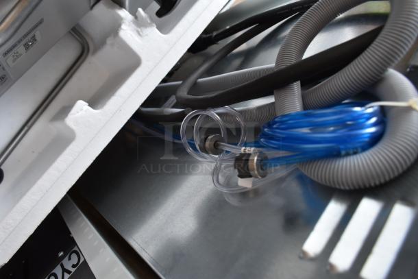 Brand new Noble 495HTGW22 stainless steel commercial undercounter dishwasher. Visible hoses and label, 208-240V, 1 phase.