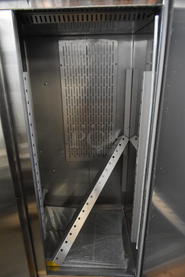 2025 Avantco 178Z2FHC stainless steel commercial 2-door reach-in freezer, interior view, visible slots for shelving, excellent condition.
