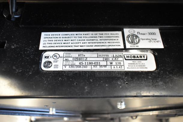 2017 Hobart HTs-7LS26 commercial scale label. Model and serial numbers visible. Operates at 120/208-240V. Tested working.