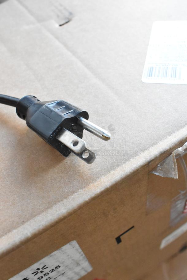 Plug of a 2017 Hobart HTs-7LS26 commercial food portioning scale, 120/208-240V, 1 Phase, on a box.