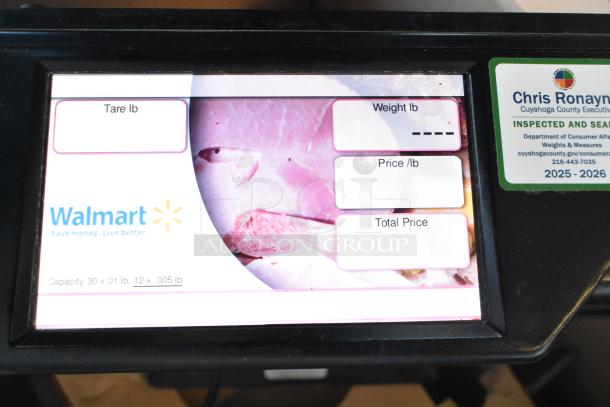 2017 Hobart HTi-7LH26 scale screen, shows tare, weight, price, with Walmart logo and inspection sticker for 2025-2026.