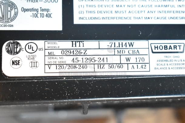 Hobart HTi-7LH4W metal commercial countertop food portioning scale tag, showing model and voltage details, tested and working.