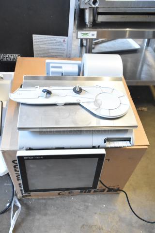 Mettler Toledo AM-5545 commercial food scale, tested and working, 100-240V, 1 phase, with display screen, on cardboard box.