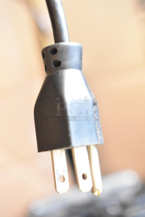 Close-up of a power plug for the 2017 Hobart HTi-7LH26 metal commercial countertop food portioning scale.