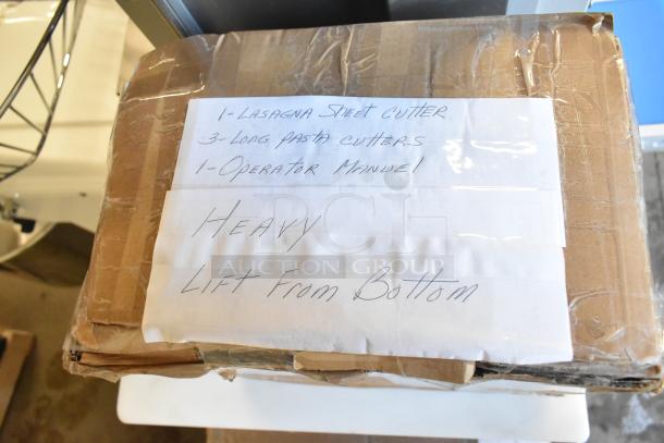 Arcobaleno AMF160 pasta machine box with lasagna sheet cutter, pasta cutters, and operator manual; marked "Heavy, Lift from Bottom."