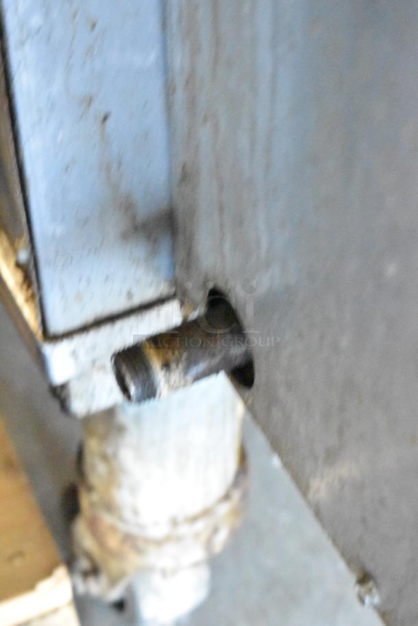 Close-up of a component from a Middleby Marshall PS638G stainless steel commercial conveyor pizza oven, showing metal detailing and connection points.